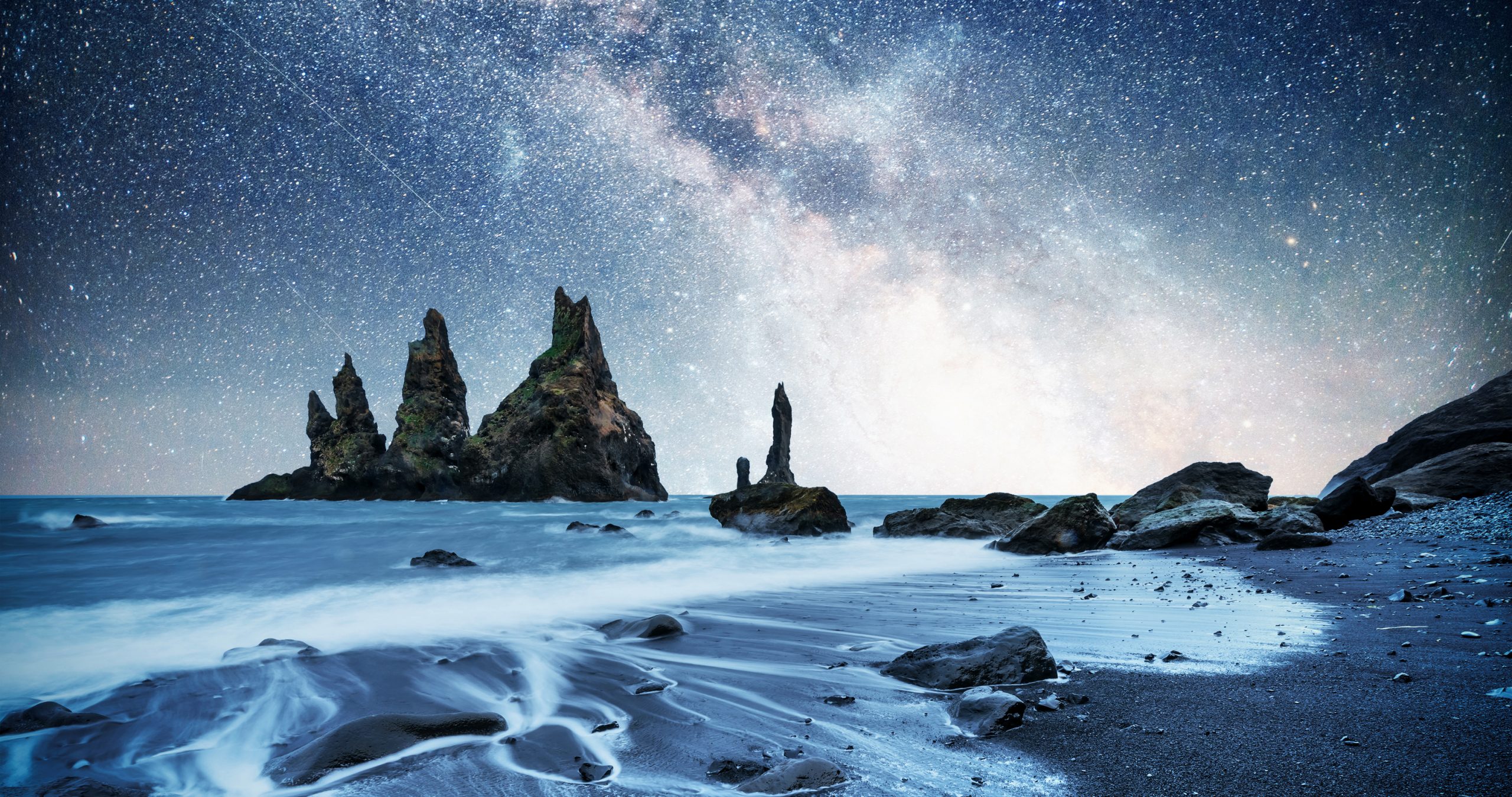 Milky Way over black sand beach and rock formations, Iceland