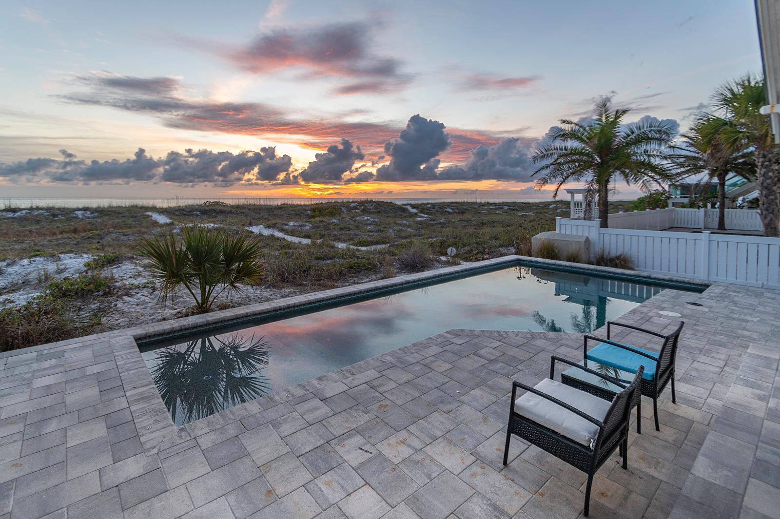 Infinity pool with sunset views behind