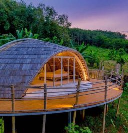 Spaceship-esque cocoon on stilts with a sunset backdrop