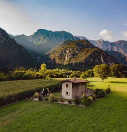 A stone farmhouse surrounded by the mointains