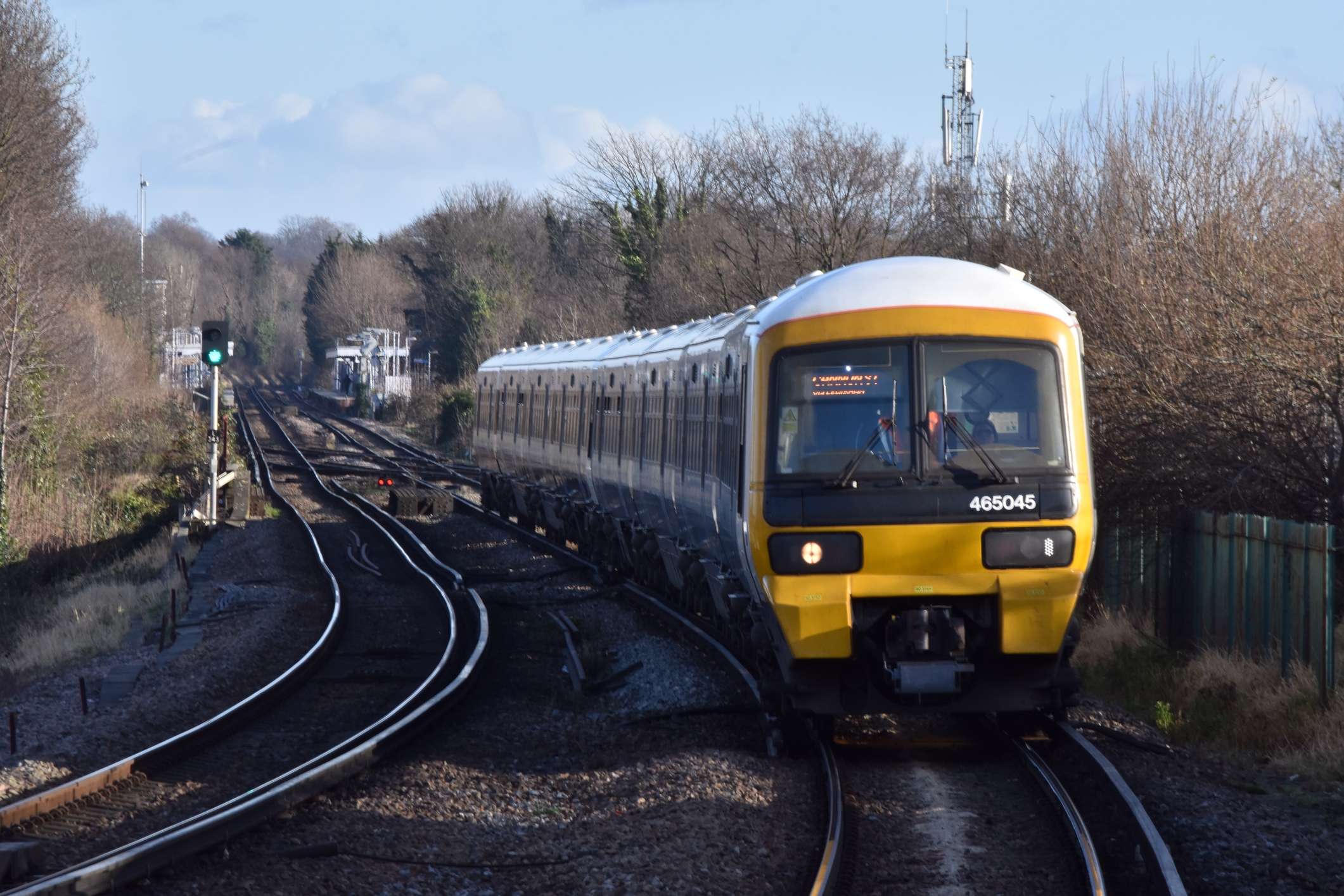 Train approaching a London station on a winter afternoon
