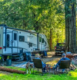 Camper with outdoor chairs at campground