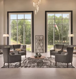 hotel lobby with grey seating and large windows that begin at the floor