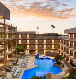 outdoor pool surrounded by multi-story hotel