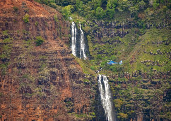 Helicopter in front of waterfall in Waimea Canyon, Kauai