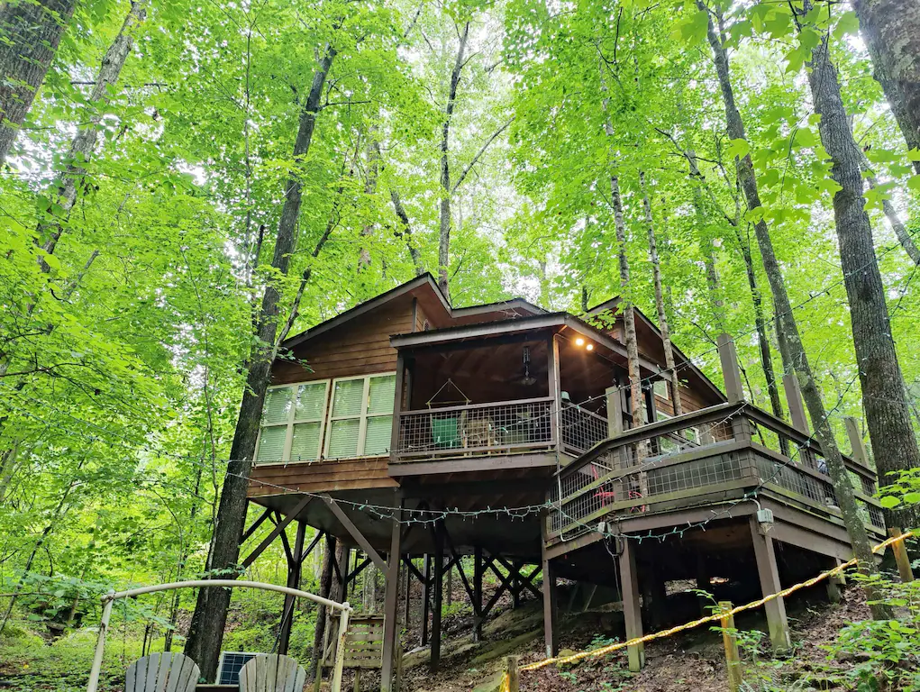 A large treehouse with a great fire pit outside