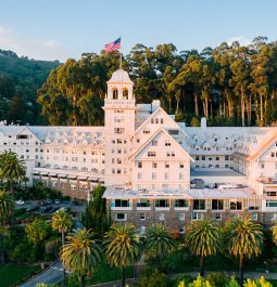 Grand hotel exterior with trees behind it