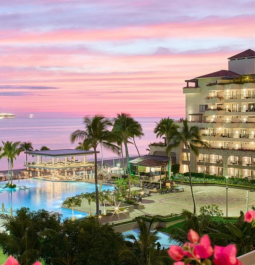 oceanfront resort wiith pool at sunset