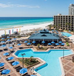 Bird's-eye view of an oceanside resort with a swimming pool