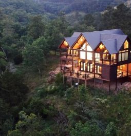 Aerial view of cabin with lights on