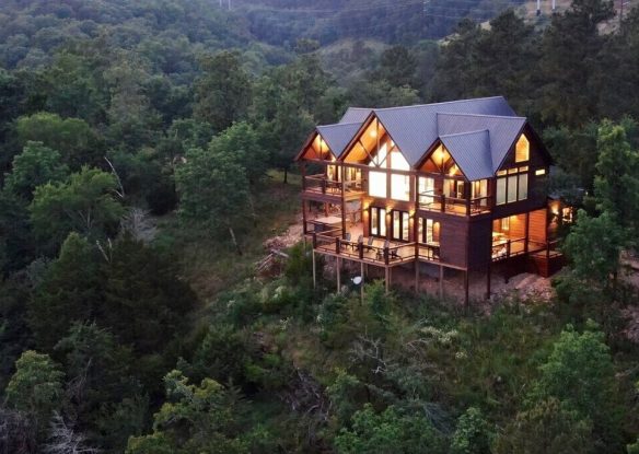 Aerial view of cabin with lights on