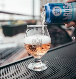 can of cider being poured in glass