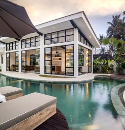 Modern black and white villa with unique shaped pool and sun loungers