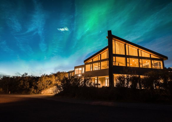 glassfront hotel under the northern lights