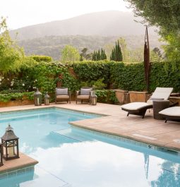 Outdoor pool surrounded by hazy hills