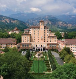 aerial view of resort surrounded by greenery and mountains