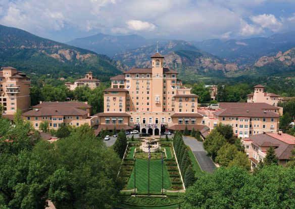 aerial view of resort surrounded by greenery and mountains