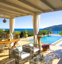 Outdoor area in a villa with a swimming pool and sea view