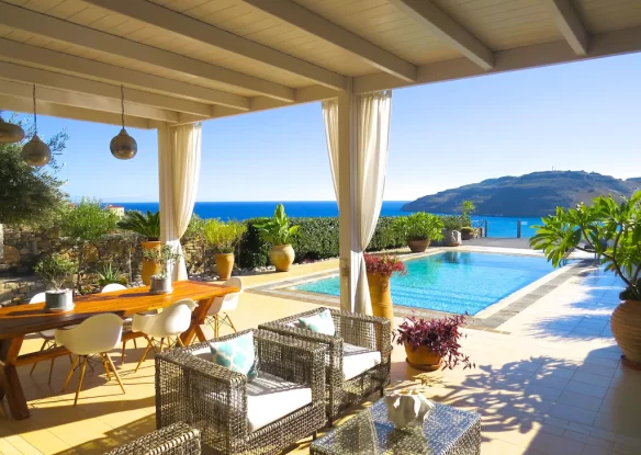 Outdoor area in a villa with a swimming pool and sea view