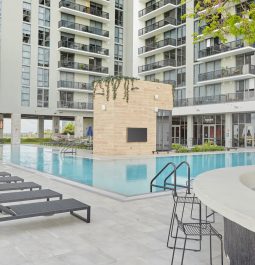 White high-rise hotel with pool in center