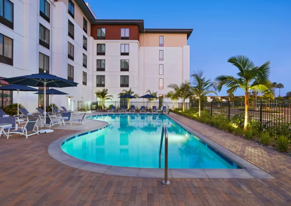 Exterior of a hotel with an outdoor swimming pool