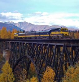 Train crossing a steel bridge in the mountains