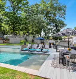 In-ground pool with patio furniture