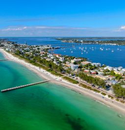 Aerial view of Cortez beach withe sand beach and his little wood pier on blue water, Anna Maria Island, Florida, USA