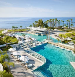 Aerial view of a seafront resort with outdoor pools