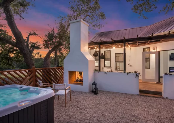 Outdoor fire place and hot tub in yard