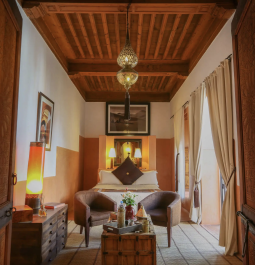 interior of hotel room with wood panel ceiling and moroccan lanterns