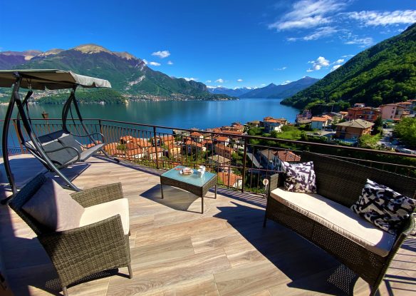 Chairs on the balcony overlooking the village, lake, and mountains