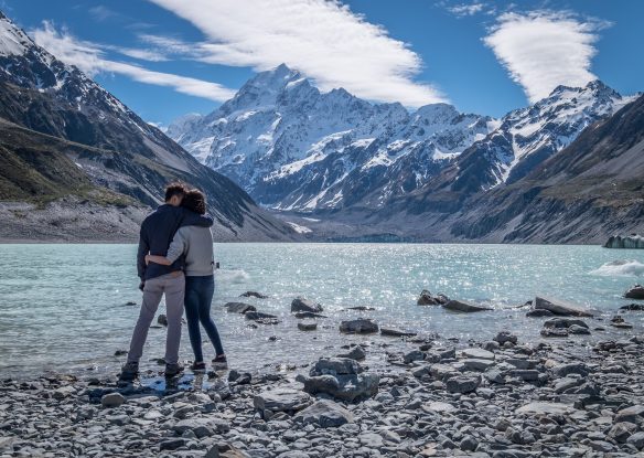 couple gazing out at a lake and mountains