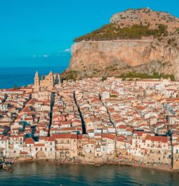 Aerial view of a historic city with a big rocky mountain