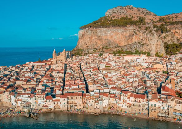 Aerial view of a historic city with a big rocky mountain